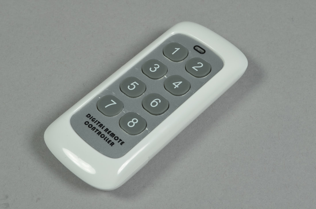 Photo of the white Brickstuff 8-button remote control transmitter.